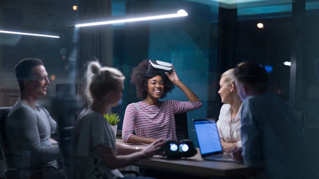 Business team using virtual reality headset during a meeting.